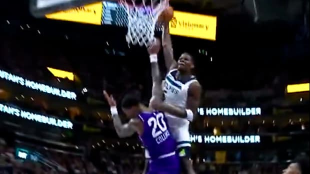 Minnesota Timberwolves guard Anthony Edwards dunks on Utah Jazz forward John Collins.